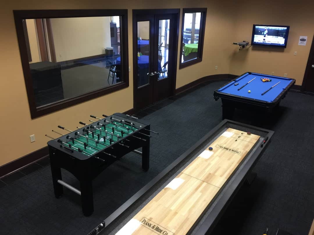 Ovrdrive game room with pool table, foosball table, and shuffleboard table